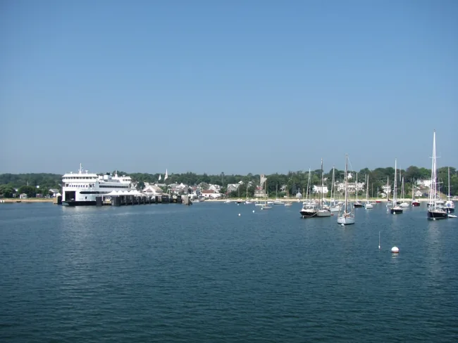 The Island Home ferry beside the Vineyard Haven terminal, with sailboats in the harbor.